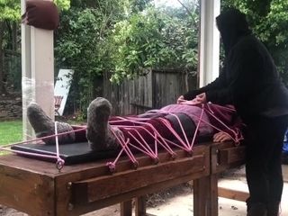 'Wool mohair layers of sweaters on a restrain bondage table '